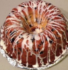 a bundt cake sitting on top of a pan covered in icing