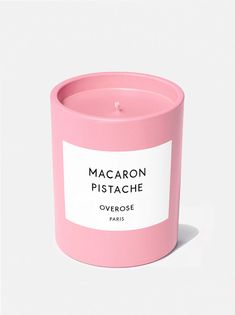 a pink candle that is sitting on a white surface with the words valikiria over it