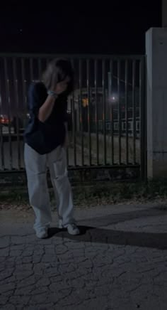 a person standing in the street at night