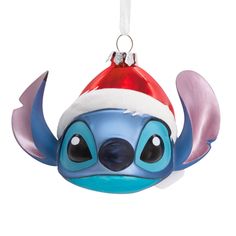 an ornament shaped like a fish with a santa hat on it's head