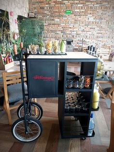 a black bike is parked next to a table