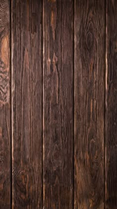 an old wooden wall with some wood grains on it's sides and brown paint