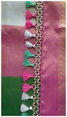 pink and green saree with tassels on it