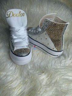 Custom Bling Chuck Taylor All Star Lift Platform. All designs handmade and embellished with a variety of high-quality crystals. Great for Quince's, weddings, proms, homecomings, birthdays, special events or just your everyday girly girl. Shoe Size: WOMEN'S size 5 to size 12 Size availability may vary based on our suppliers current inventory. If your size is out of stock at the time of your order we will notify you within 48 hours. ** PLEASE NOTE CONVERSE CHUCK TAYLOR SNEAKERS RUN ABOUT A WHOLE SIZE BIG, IF YOU'VE NEVER HAD A PAIR, I STRONGLY RECOMMEND TRYING A PAIR ON TO ENSURE CORRECT SIZE. ** Chuck Taylor All Star Lift Platform Embellished with high quality Gold, Silver, White stones. White Satin ribbon laces (original shoestrings provided with all orders) (NEW SHOES GUARANTEED) THESE CA Bling Converse Shoes, Mickey Shoes, Bedazzled Shoes, White Chucks, Bling Converse, Chuck Taylor All Star Lift, Ribbon Laces, Winter Wonderland Theme, Surprise Az