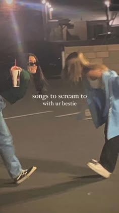 two people are dancing in the middle of an empty parking lot, one is holding a drink