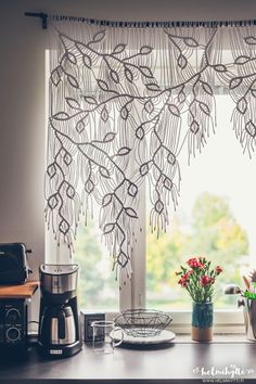 a kitchen window with curtains made out of beads