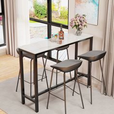 a dining table with three stools in front of it