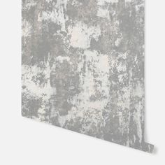 an old, grungy wallpaper with white and gray paint on it's surface