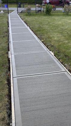 a skateboarder is riding down a concrete path