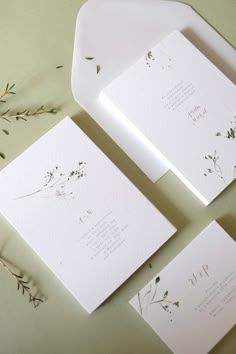 the wedding stationery is laid out on top of each other