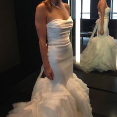 a woman in a wedding dress is taking a selfie