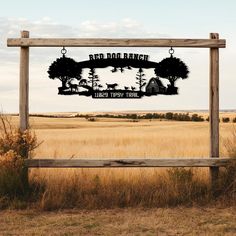 a sign in the middle of a field that says red dollar ranch with deer and trees on it