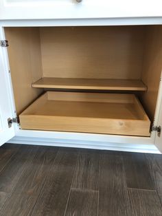 an open cabinet door on the inside of a kitchen