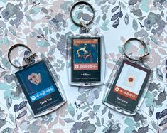 three keychains with different types of cards on them