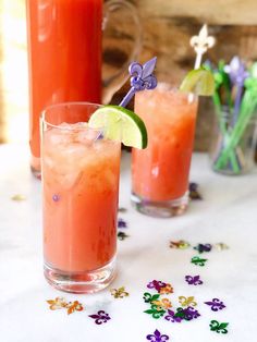 two glasses filled with drinks sitting on top of a table