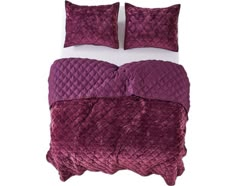 a bed with purple comforters and pillows on top of wooden floor next to wall