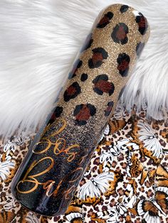 an animal print tube with the word love on it sitting on top of a white fur