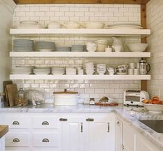 a kitchen filled with lots of white dishes