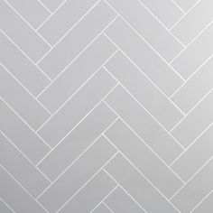 a white tile wall with herringbone pattern in the center and bottom part on each side