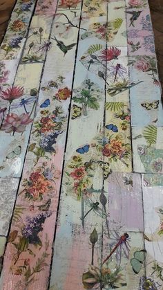 the table is covered with many different colored flowers and butterflies on it's sides