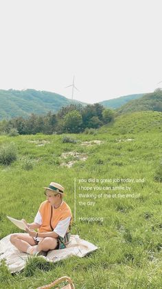 a person sitting on top of a blanket in the grass