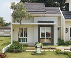 a small white house with trees in the front yard