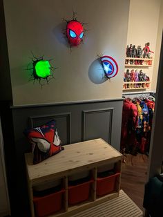 a room filled with lots of toys and lights on the wall next to a wooden table