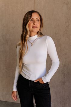 Embrace classic style with the Maren Ribbed Long Sleeve Top. Made from soft ribbed fabric, this top offers both comfort and sophistication. The high neckline adds a touch of elegance, while the long sleeves ensure you stay warm and stylish. Available in black, grey, and white, the Maren top is a versatile essential that pairs effortlessly with any bottom, making it perfect for layering or wearing solo. Elevate your wardrobe with this timeless piece that effortlessly combines form and function. Ribbed Long Sleeve Top, Faux Leather Purse, White Bodycon Dress, Travel Dress, Hair Fragrance, Jumpsuit Shorts Rompers, Maxi Dresses Casual, Short Jumpsuit, Romper Pants