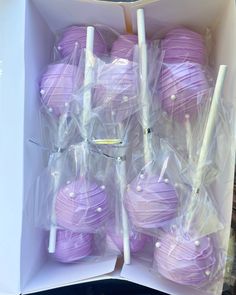 purple cake pops are wrapped in plastic and ready to be eaten