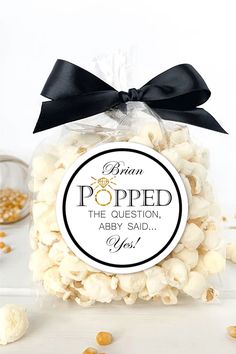 a bag filled with white popcorn sitting on top of a table