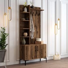 a wooden cabinet sitting on top of a hard wood floor next to a potted plant