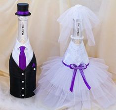 two wine bottles dressed up as bride and grooms, one in tuxedo