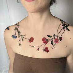 a woman with flowers on her chest is smiling