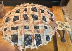 an old fashioned pie is on display in a store window, with a price tag attached to it