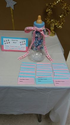 a baby bottle with its lid on top of a table next to some candy bars