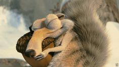 a stuffed animal is sitting on the back of a large furry animal with it's eyes closed