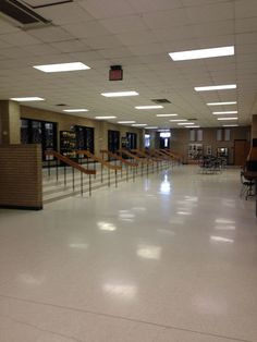 an empty room with several tables and chairs