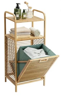 a bamboo shelf with towels and soaps on it