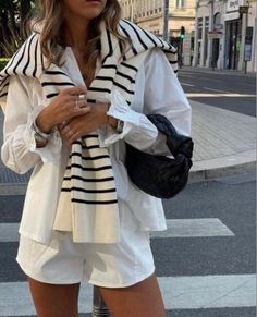 This is a striking fashion statement with this chic and classic women's outfit that combines the timeless allure of white with the playful charm of stripes🦓. Pair a crisp white blouse with a striped cardigan for an elegant and sophisticated look that exudes confidence and style✨ Looks Pinterest, Skandinavian Fashion, Stockholm Fashion, Mode Inspo