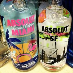 two bottles of absolut are sitting on a counter top next to each other