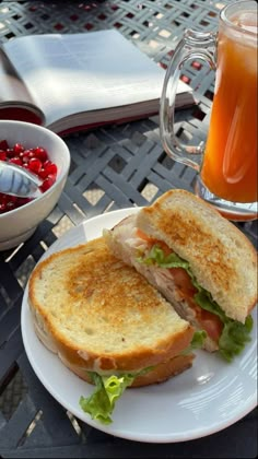 a sandwich on a plate next to a cup of tea