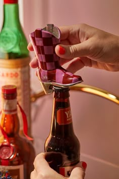 a woman is holding a bottle opener in her hand