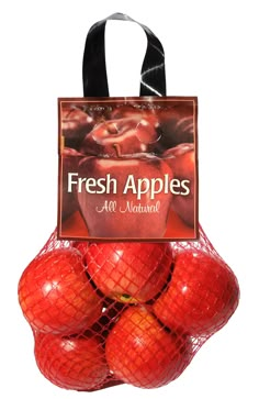 fresh apples are in a mesh bag on display