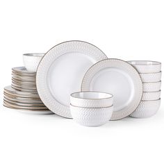 a stack of white and gold dinnerware