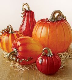 a group of pumpkins sitting on top of hay