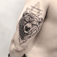 a man's arm with a bear tattoo on it and geometric shapes around him