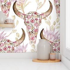 the wallpaper is decorated with pink flowers and an animal's skull on it