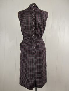 "Vintage 1950s dress. Made of black nubby cotton with red and white windowpane plaid. Has decorative back buttons, two pockets, sleeveless and side zipper. No label. Size small. Actual measurements are: 37\" around the bust 28\" around the waist 38\" around the hips 14\" shoulder to shoulder 41\" overall length In very good condition." Fitted Sleeveless Plaid Vintage Dress, Retro Plaid Fitted Vintage Dress, Fitted Sleeveless Vintage Plaid Dress, Fitted Vintage Cotton Plaid Dress, Retro Cotton Plaid Dress, Windowpane Plaid, Checkered Dress, Vintage 1950s Dresses, 1950s Dress