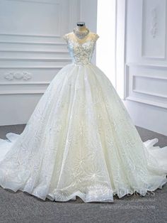 a white wedding dress on display in front of a window