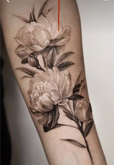 a woman's arm with flowers on it